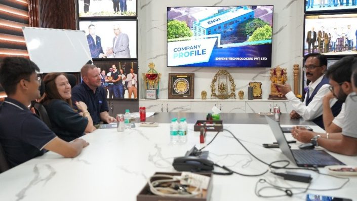 Jake meeting the Envisys owners Anil and Patel in the Envisys conference room.